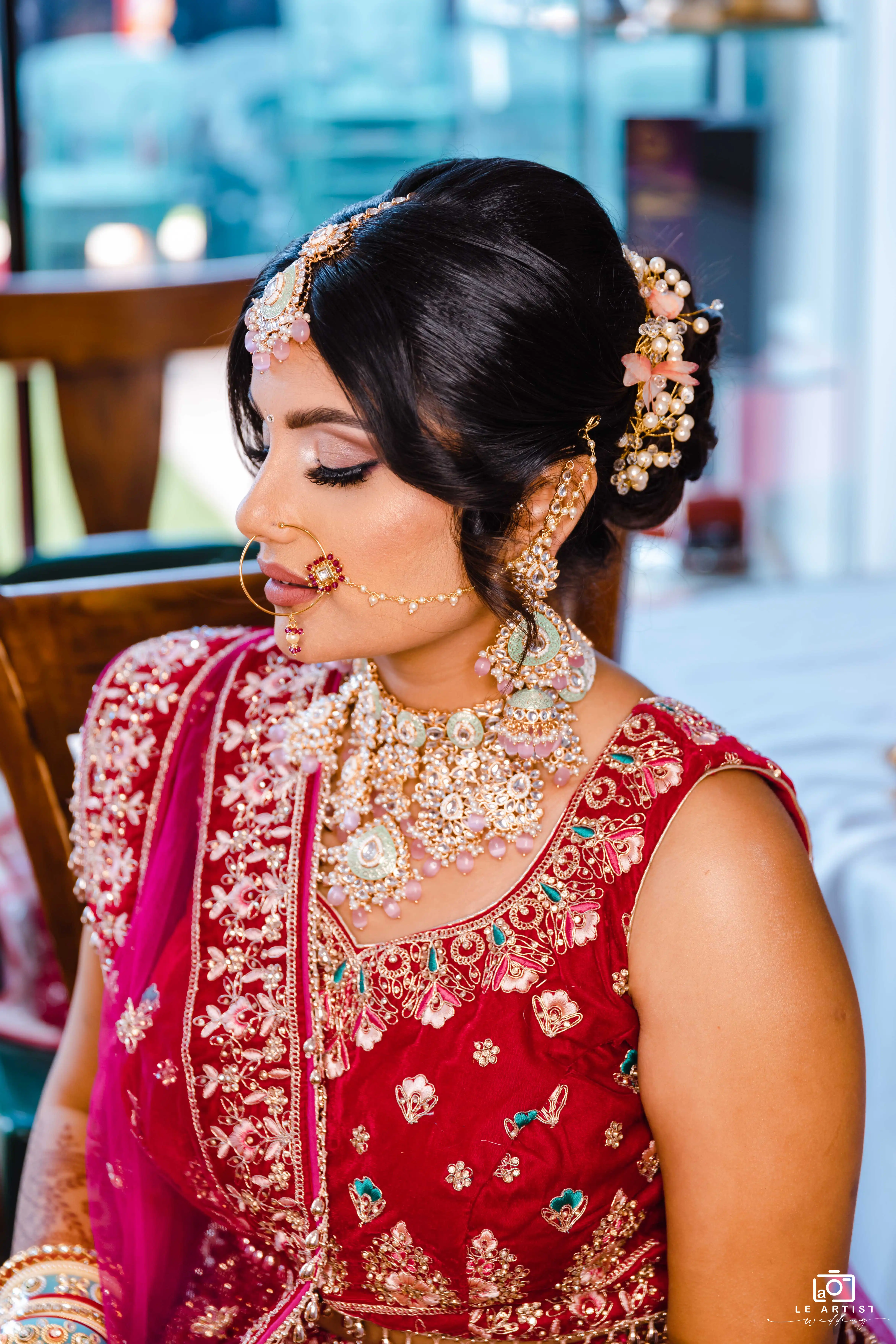 A bride in intricate traditional attire prepares for the wedding ceremony. Le Artist Wedding