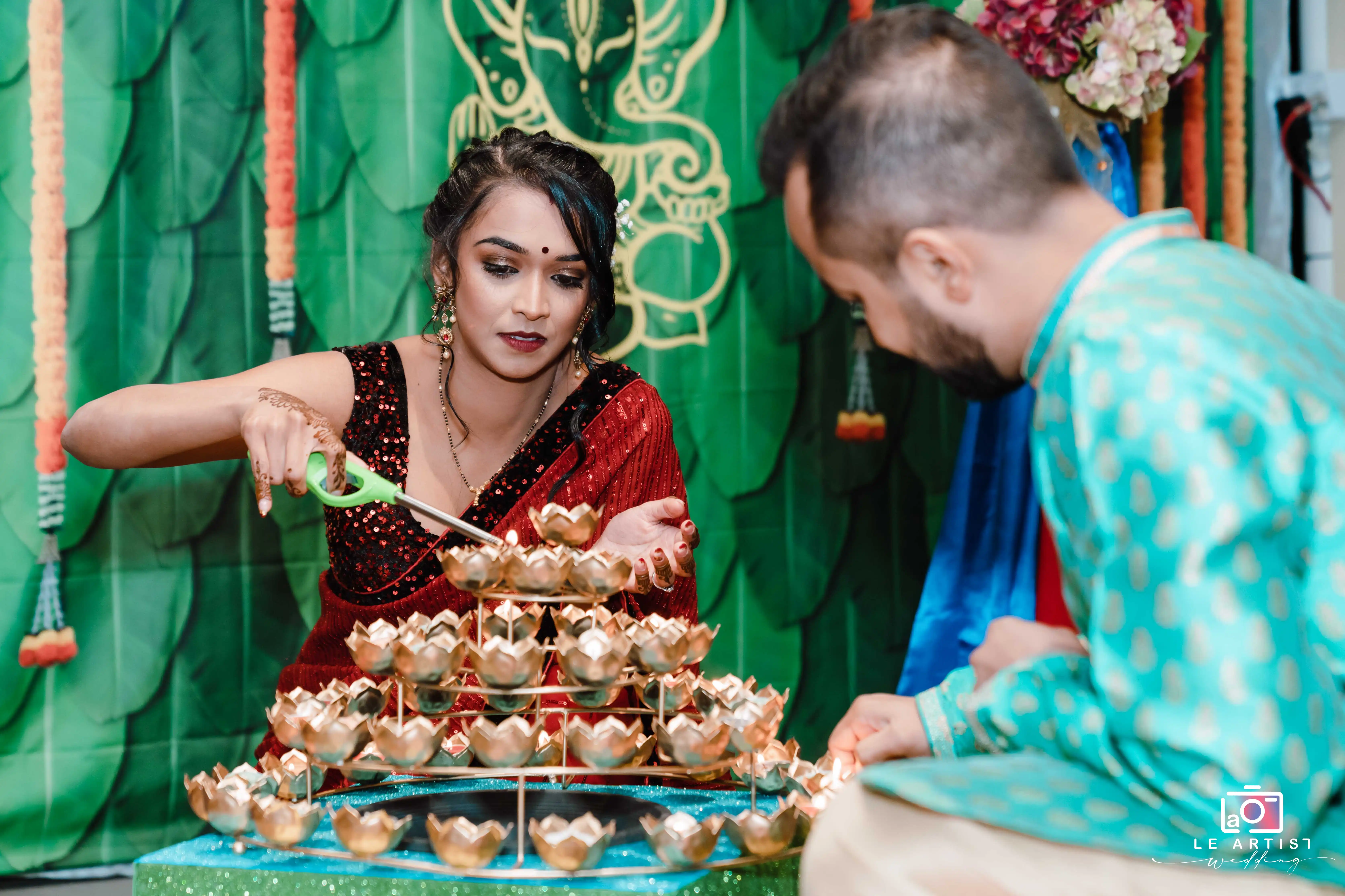 A ceremonial lighting ritual being performed with intricate candle arrangements, adding a traditional touch to the wedding ceremony. Le Artist Wedding