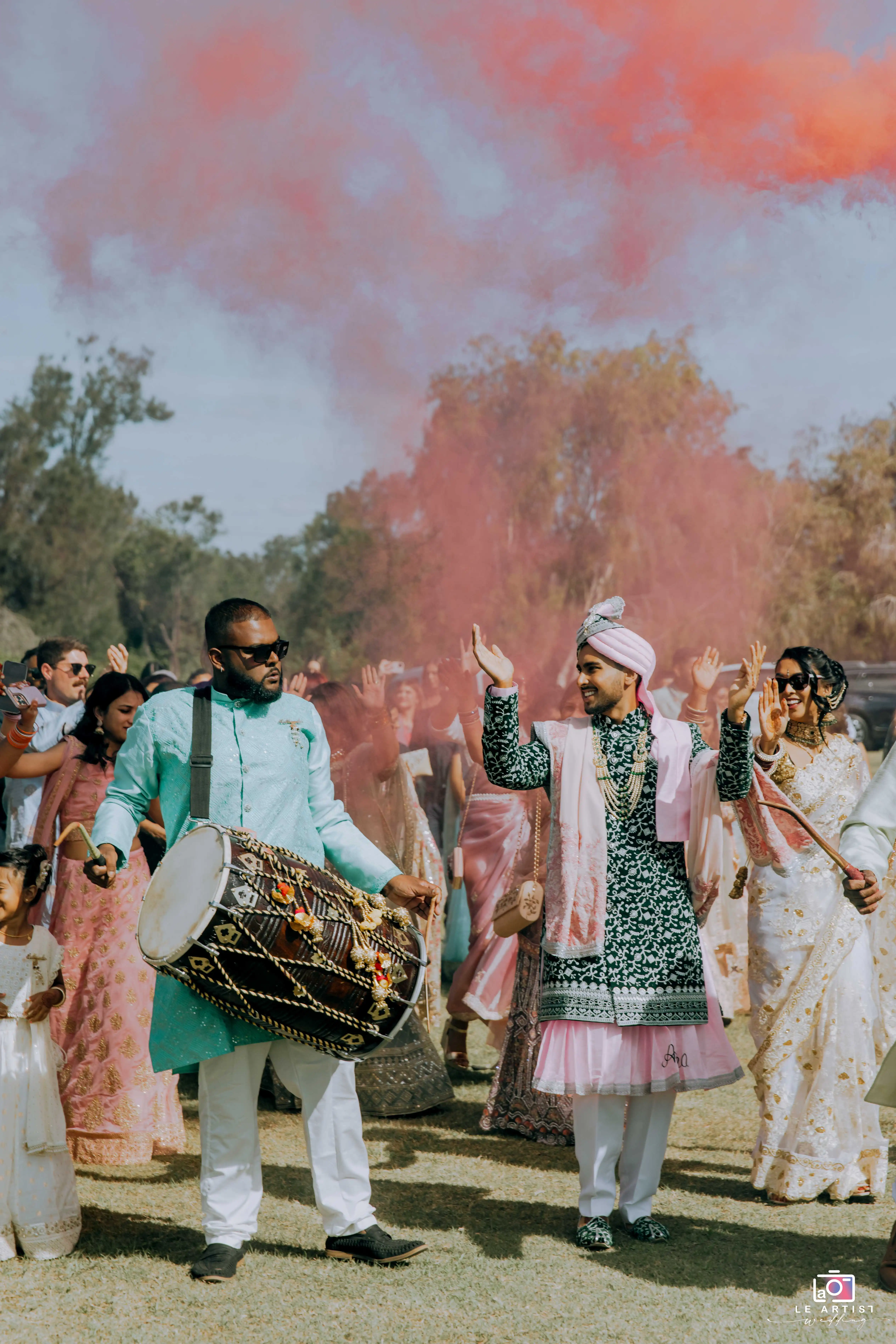 Vibrant entrance procession with drum and colorful smoke at the wedding ceremony. Le Artist Wedding