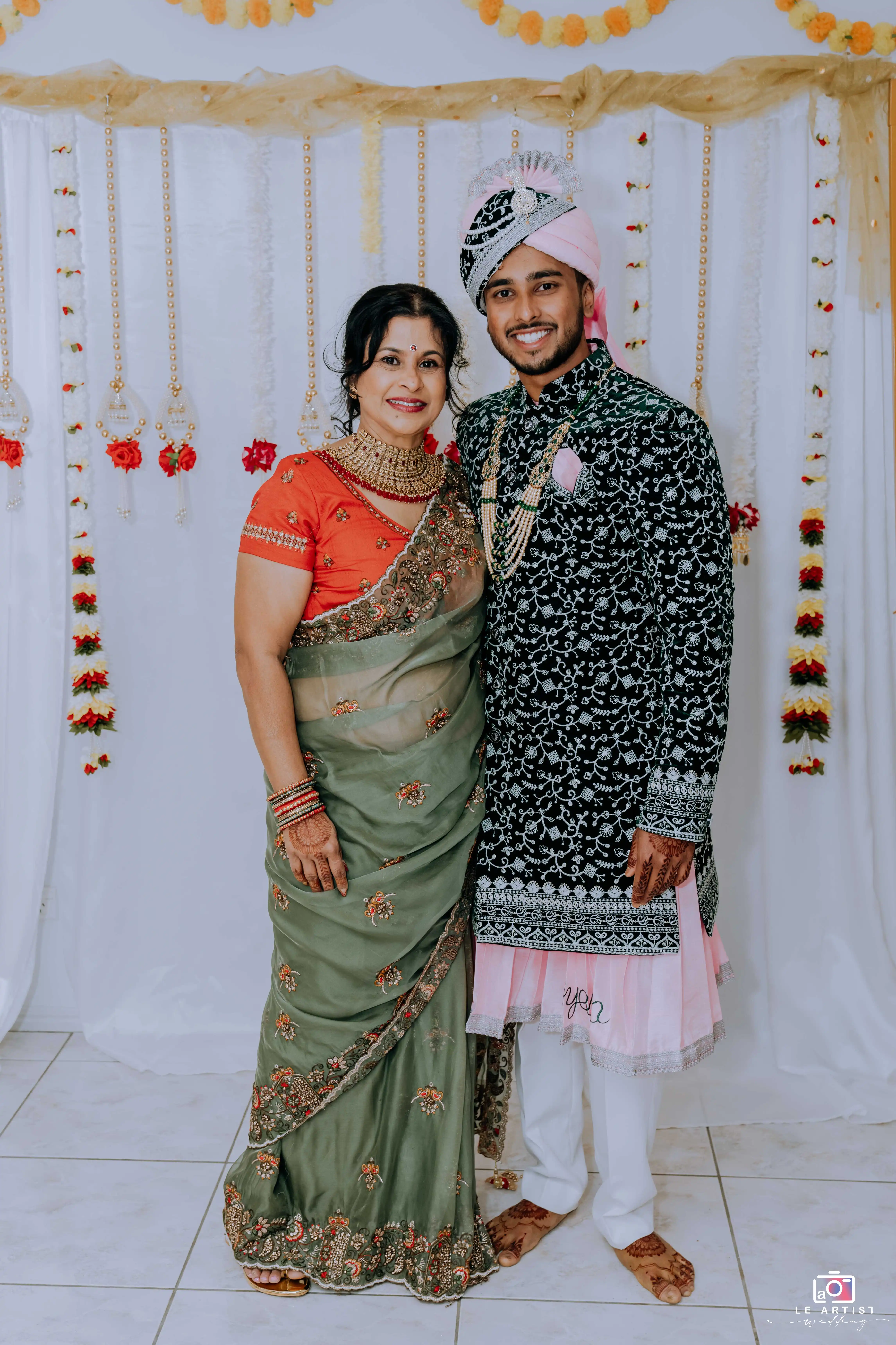 A joyful moment captured with the groom and a family member in traditional attire. Le Artist Wedding