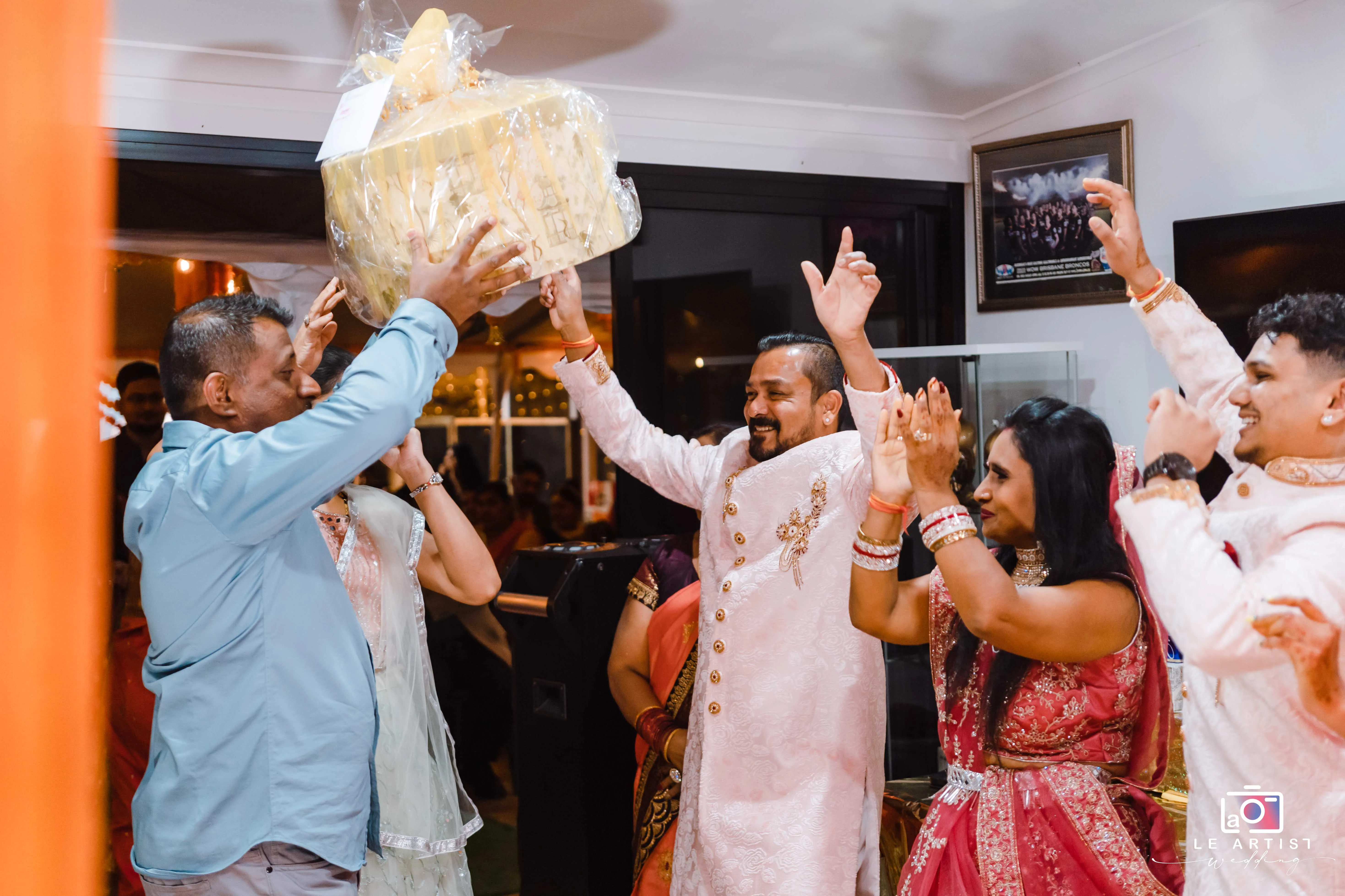 Guests celebrating and presenting a gift during the wedding reception. Le Artist Wedding