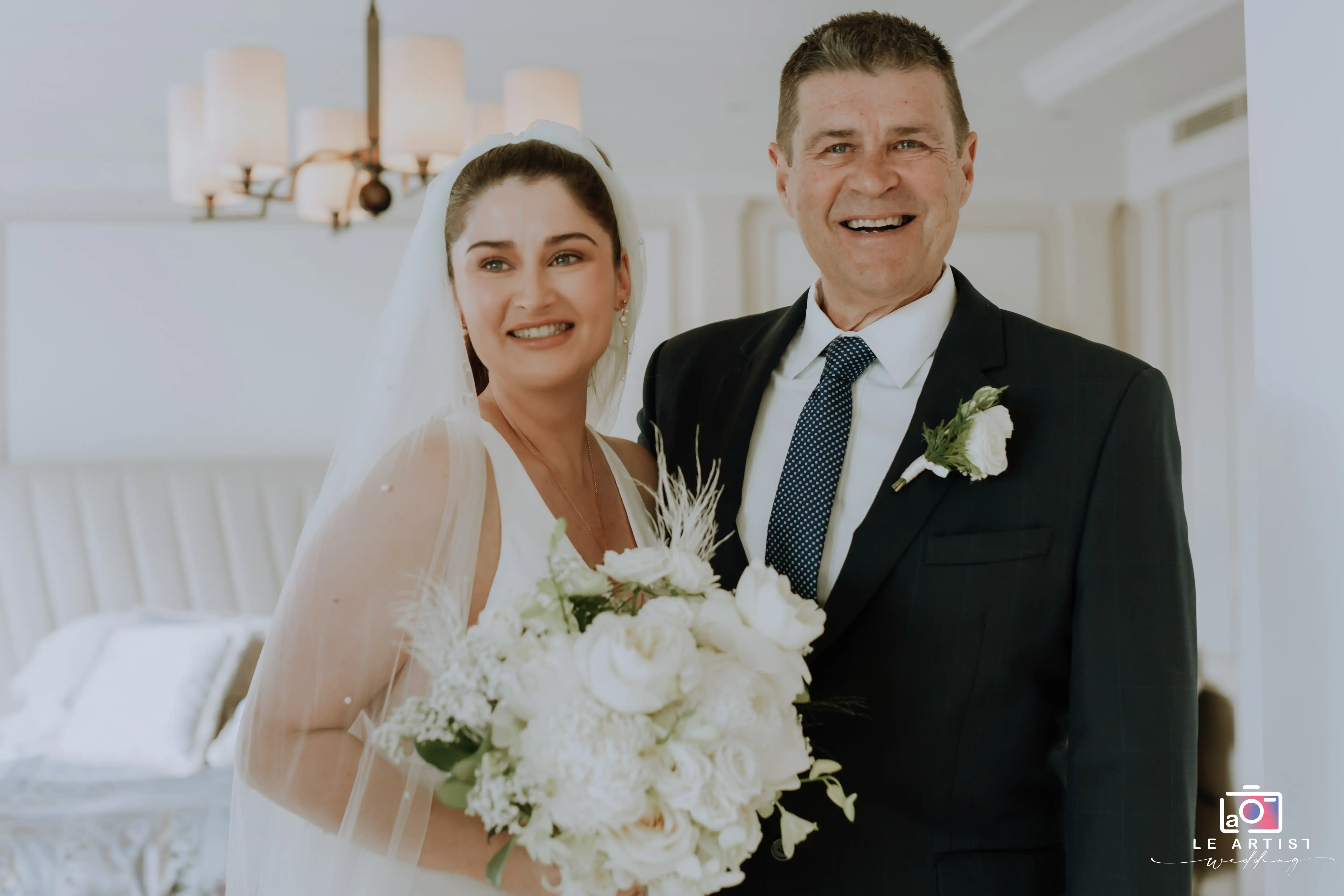 A joyful moment between the bride and her father as they prepare for the wedding ceremony. Le Artist Wedding