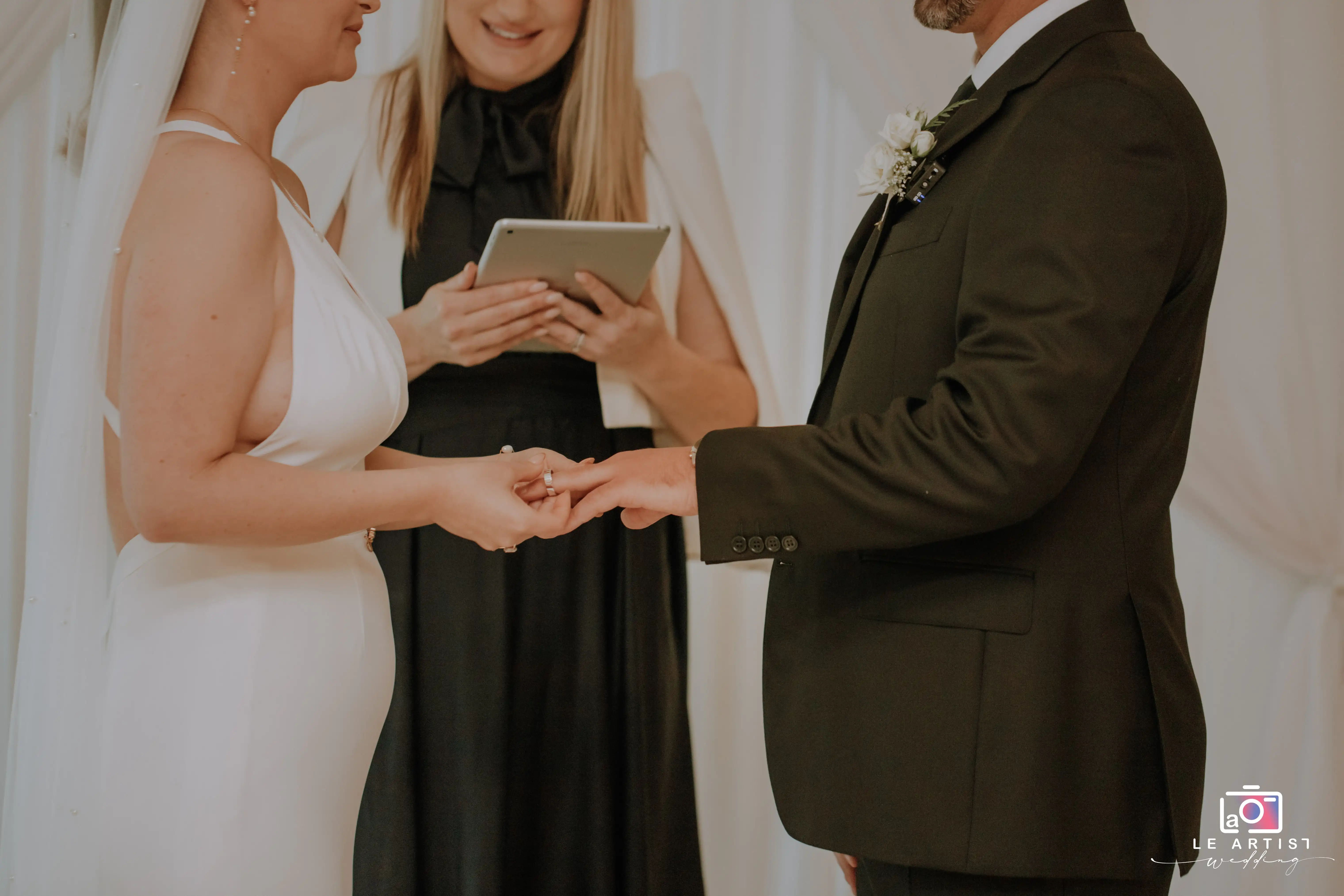 A touching moment during the ceremony where the couple exchanges rings, signifying their commitment to each other. Le Artist Wedding