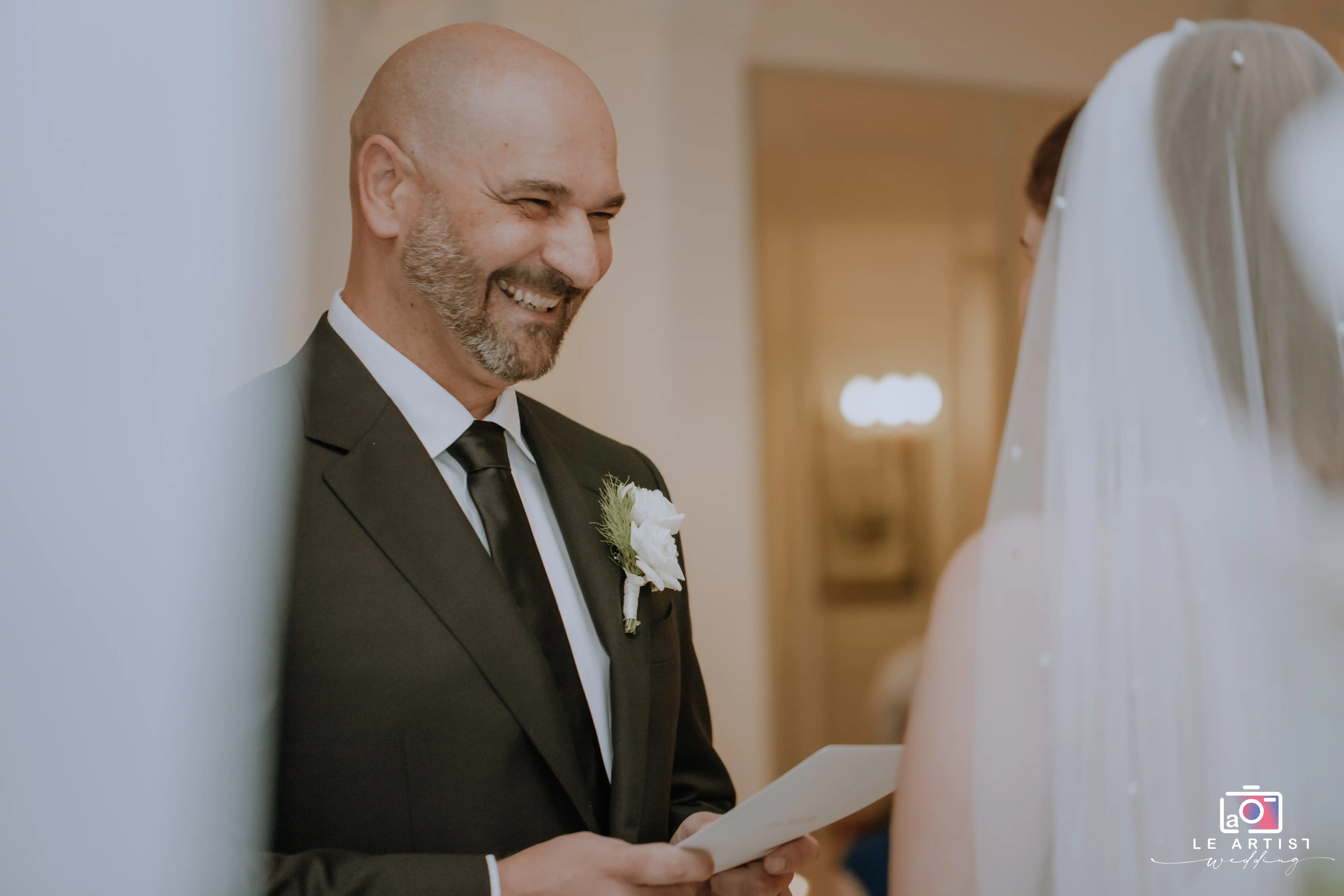 A joyful moment during the exchange of vows at the wedding ceremony. Le Artist Wedding
