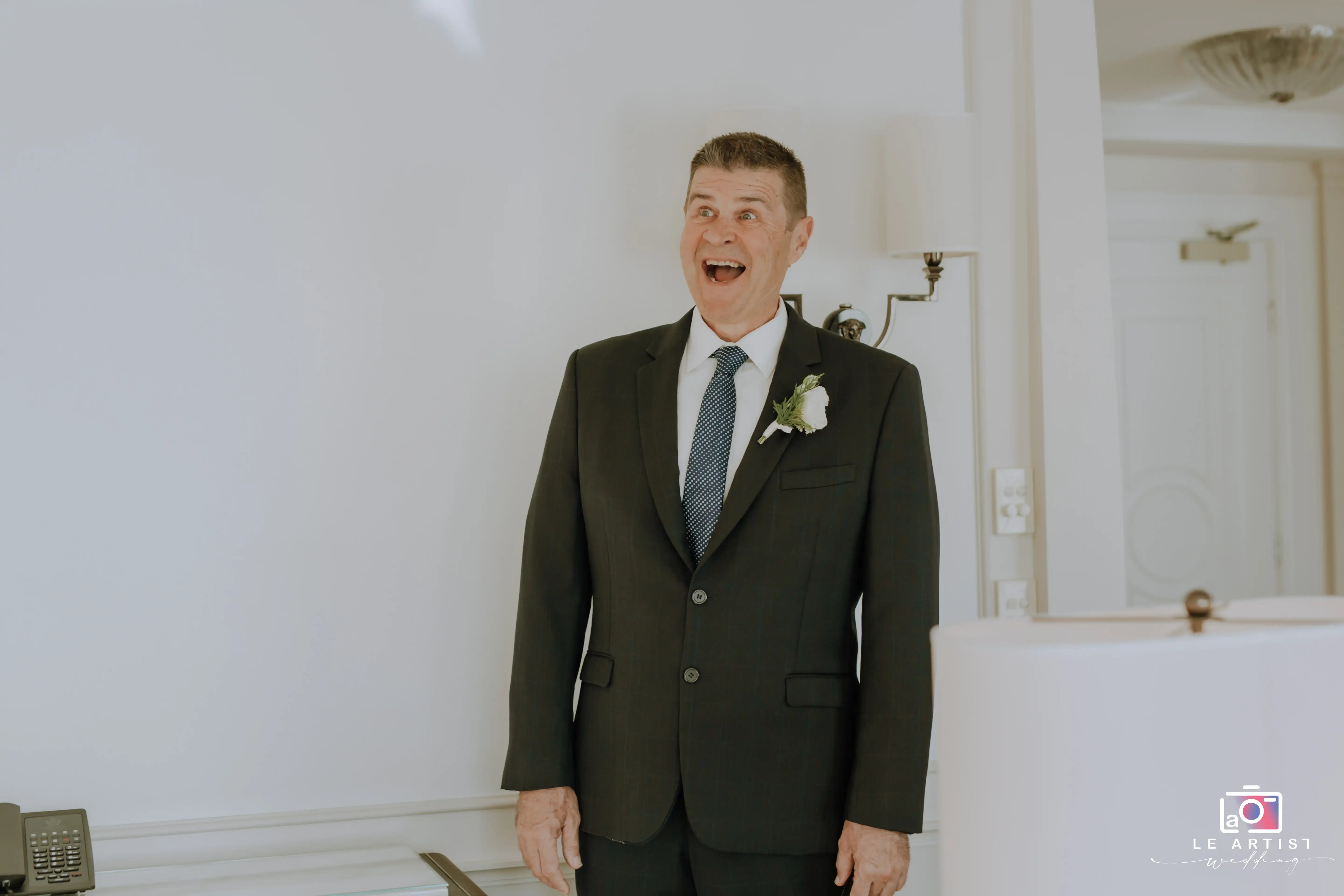 A joyous reaction captures a heartfelt moment during the preparations before the wedding ceremony. Le Artist Wedding
