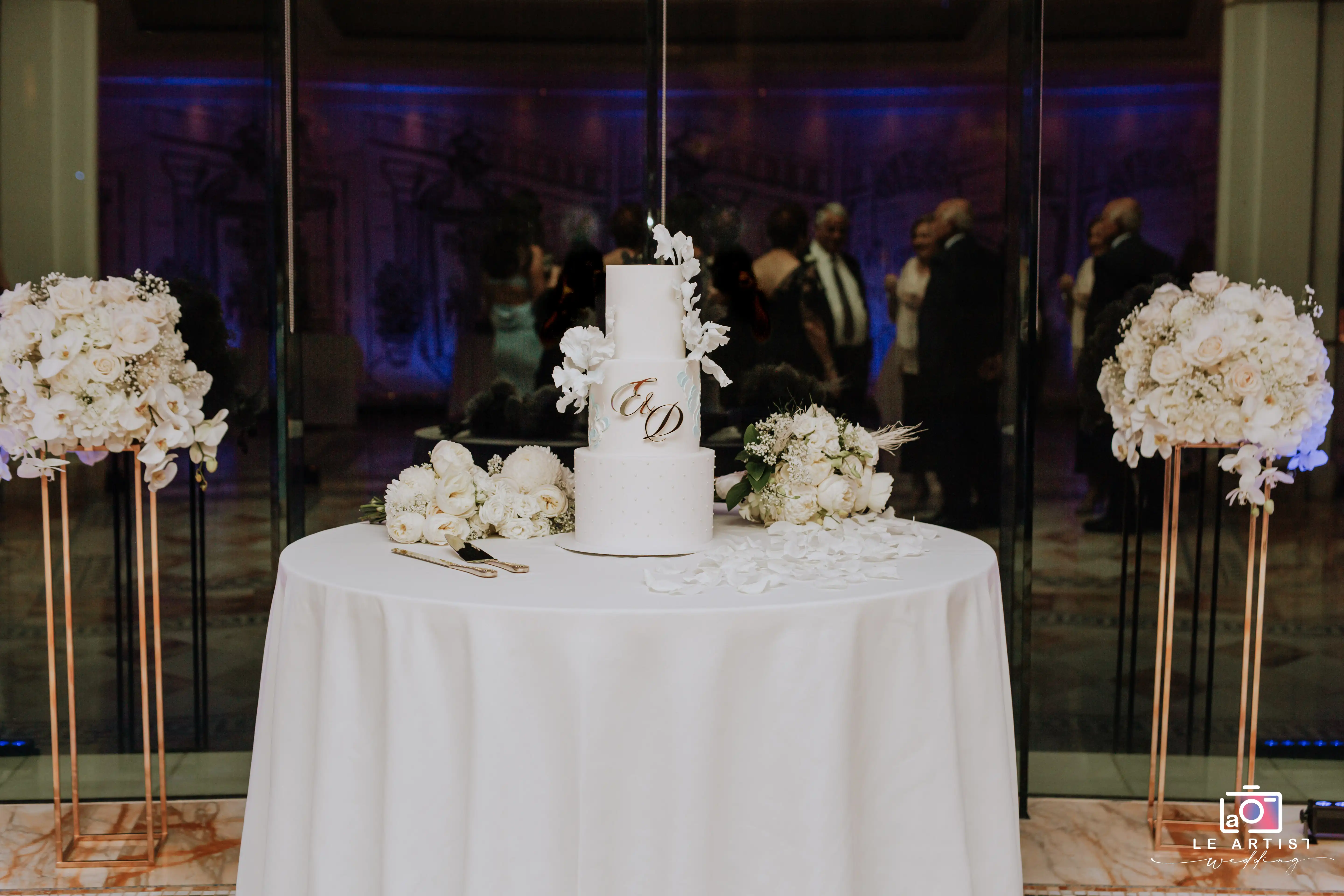 A beautifully decorated wedding cake table ready for the cake-cutting ceremony during the reception. Le Artist Wedding