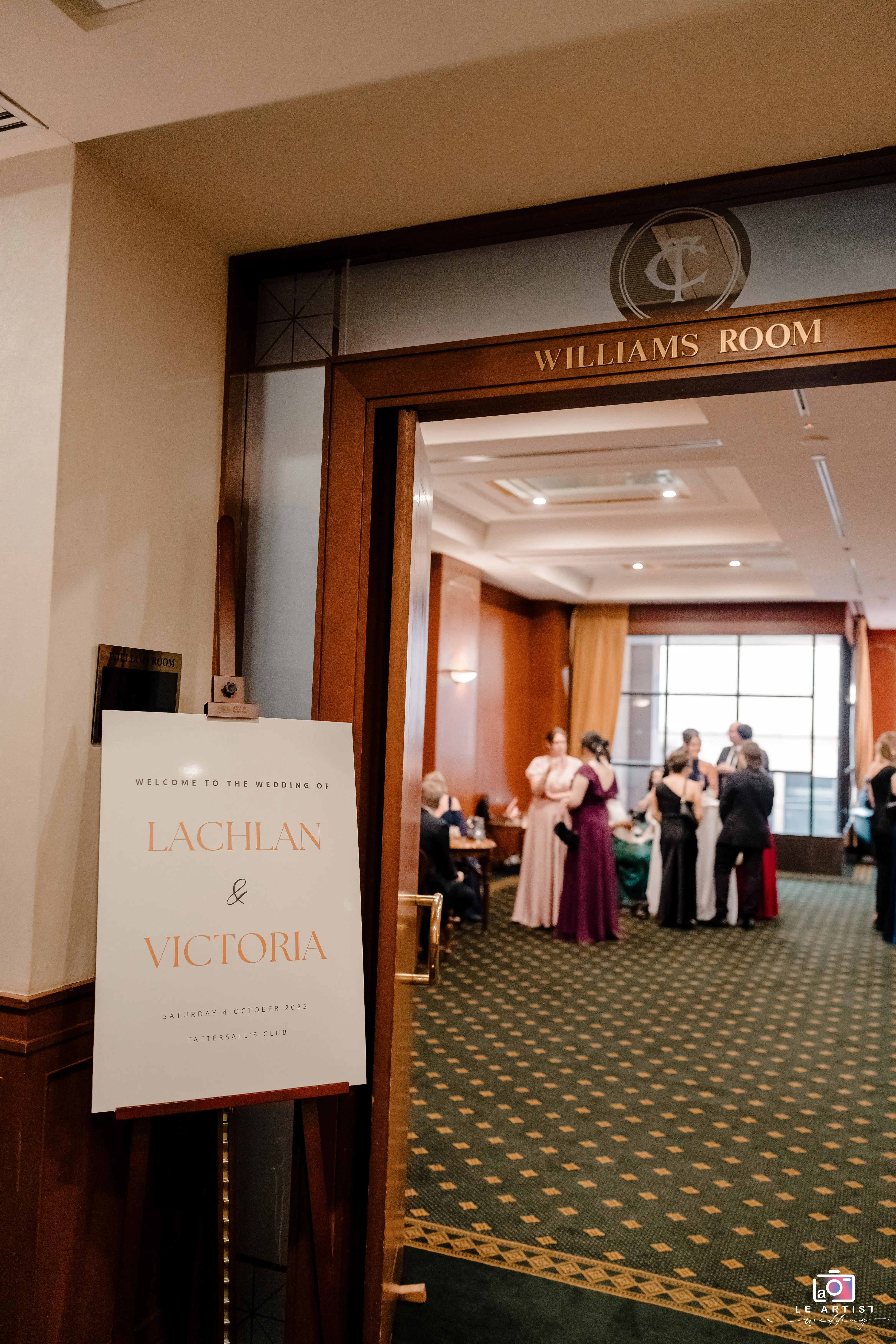 Entry to the wedding at the Williams Room with a sign welcoming guests to Lachlan and Victoria's celebration. Le Artist Wedding