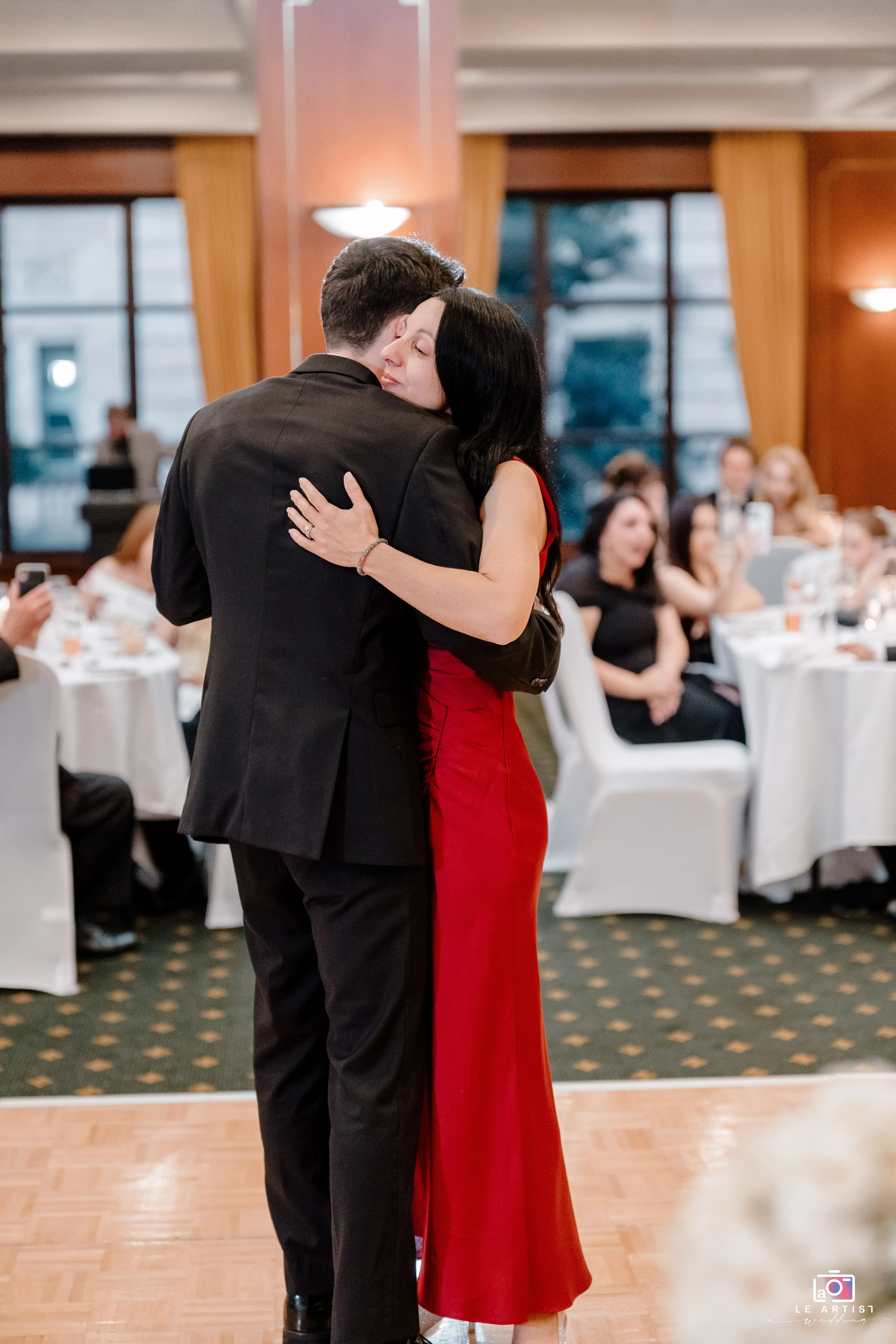 A touching embrace captures a heartfelt moment on the dance floor during the wedding reception. Le Artist Wedding
