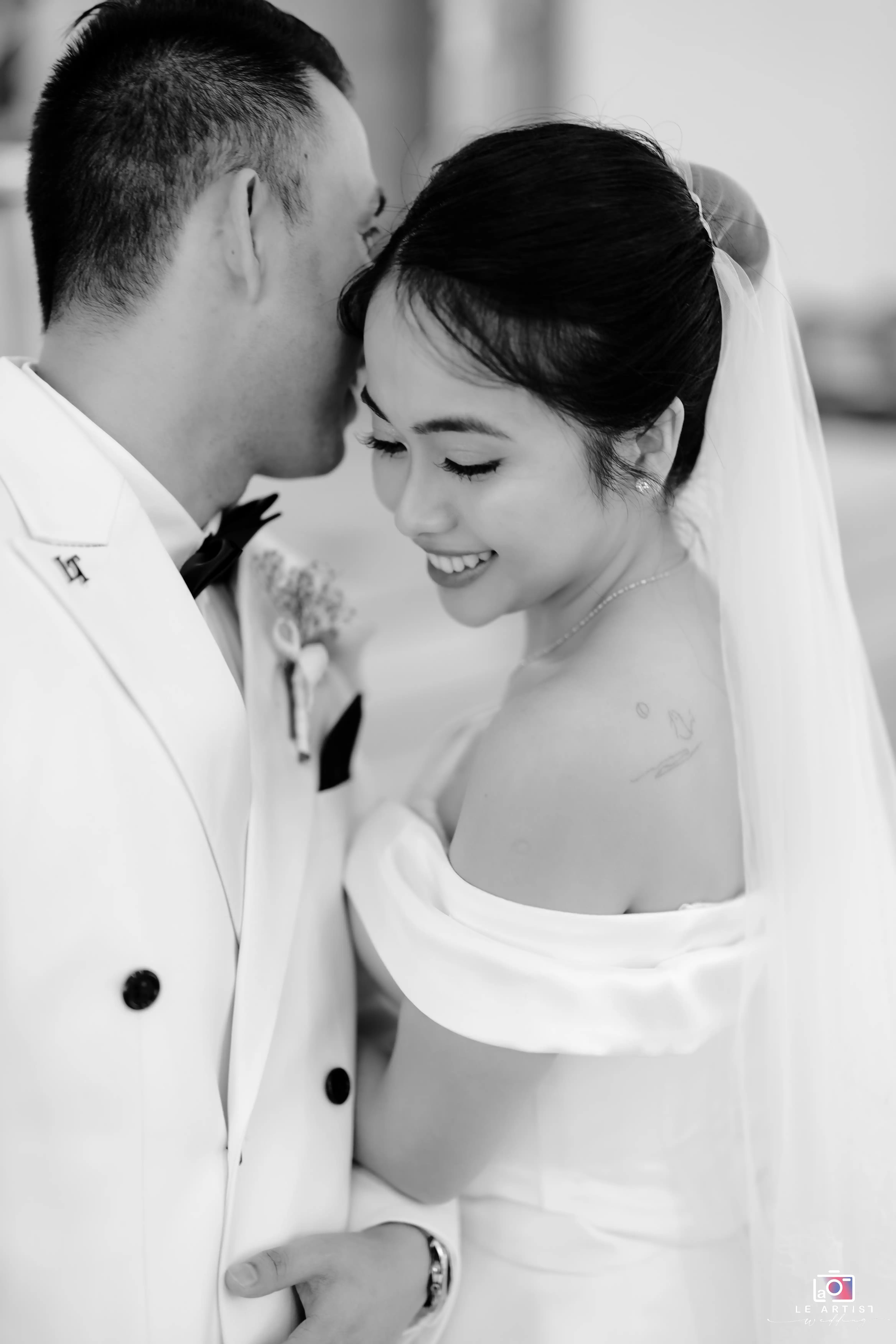 A tender moment captured in black and white, highlighting the intimacy and joy between the newlywed couple. Le Artist Wedding