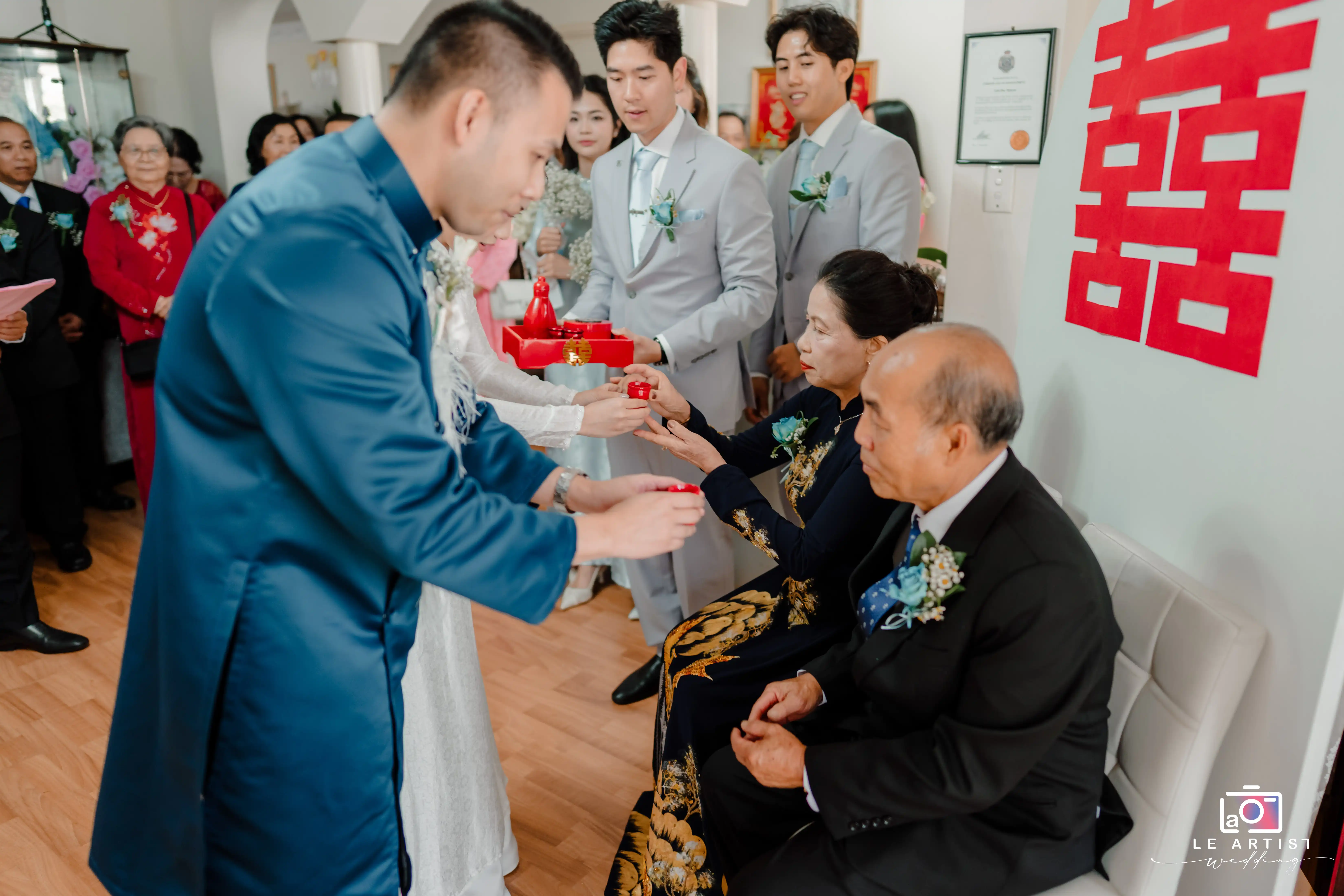 The couple performs a traditional tea ceremony, serving tea to their parents as a sign of respect and gratitude. Le Artist Wedding