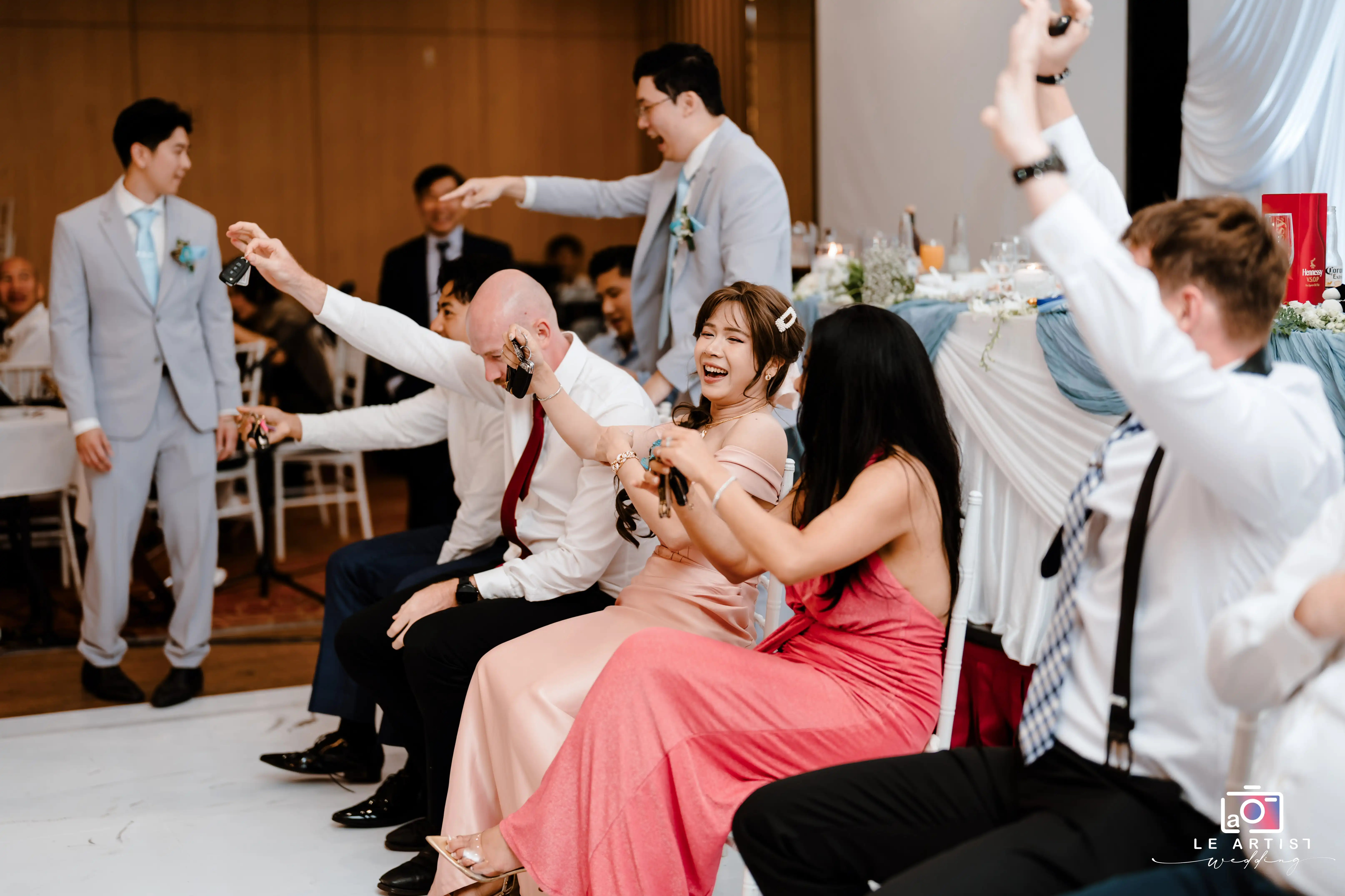 Guests enjoy a lively game at the wedding reception, showcasing their excitement and camaraderie. Le Artist Wedding
