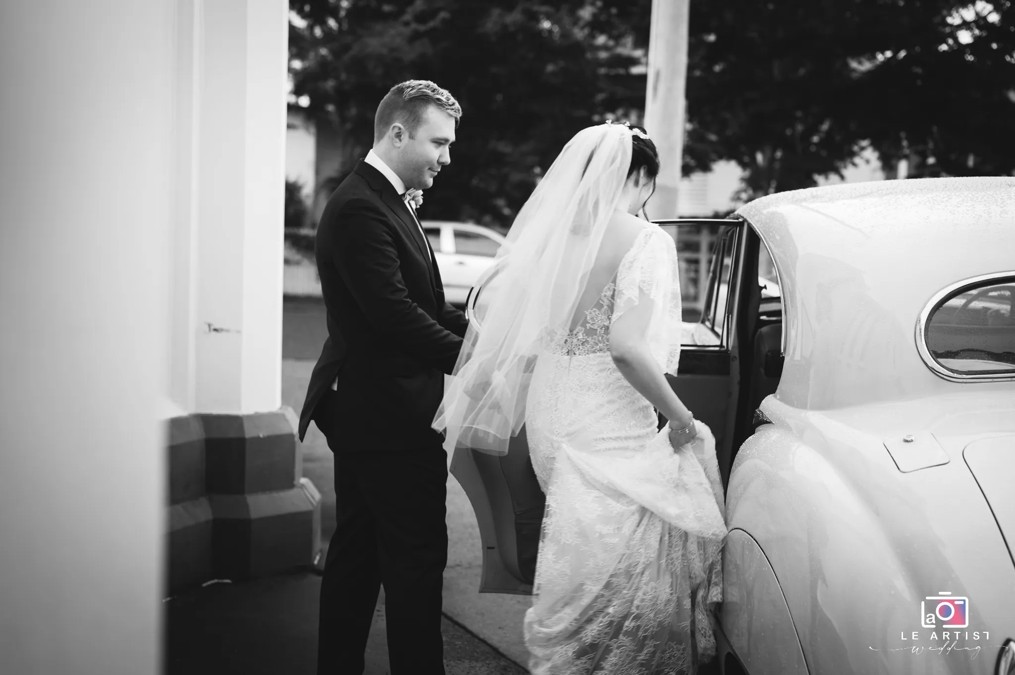 The couple prepares to depart in a classic car, marking the beginning of their journey together as newlyweds. Le Artist Wedding
