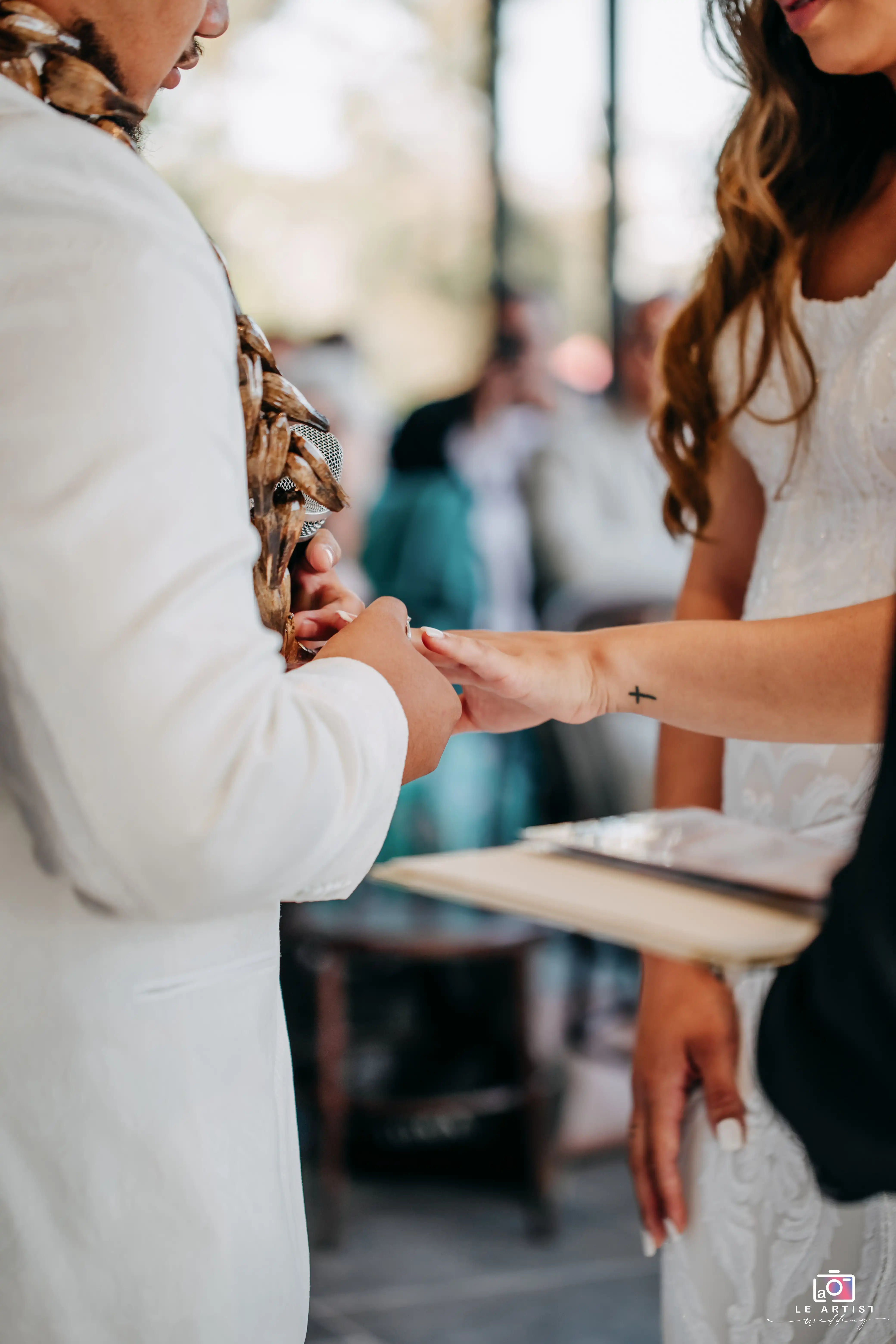 The couple shares a heartfelt moment during the ring exchange ceremony. Le Artist Wedding