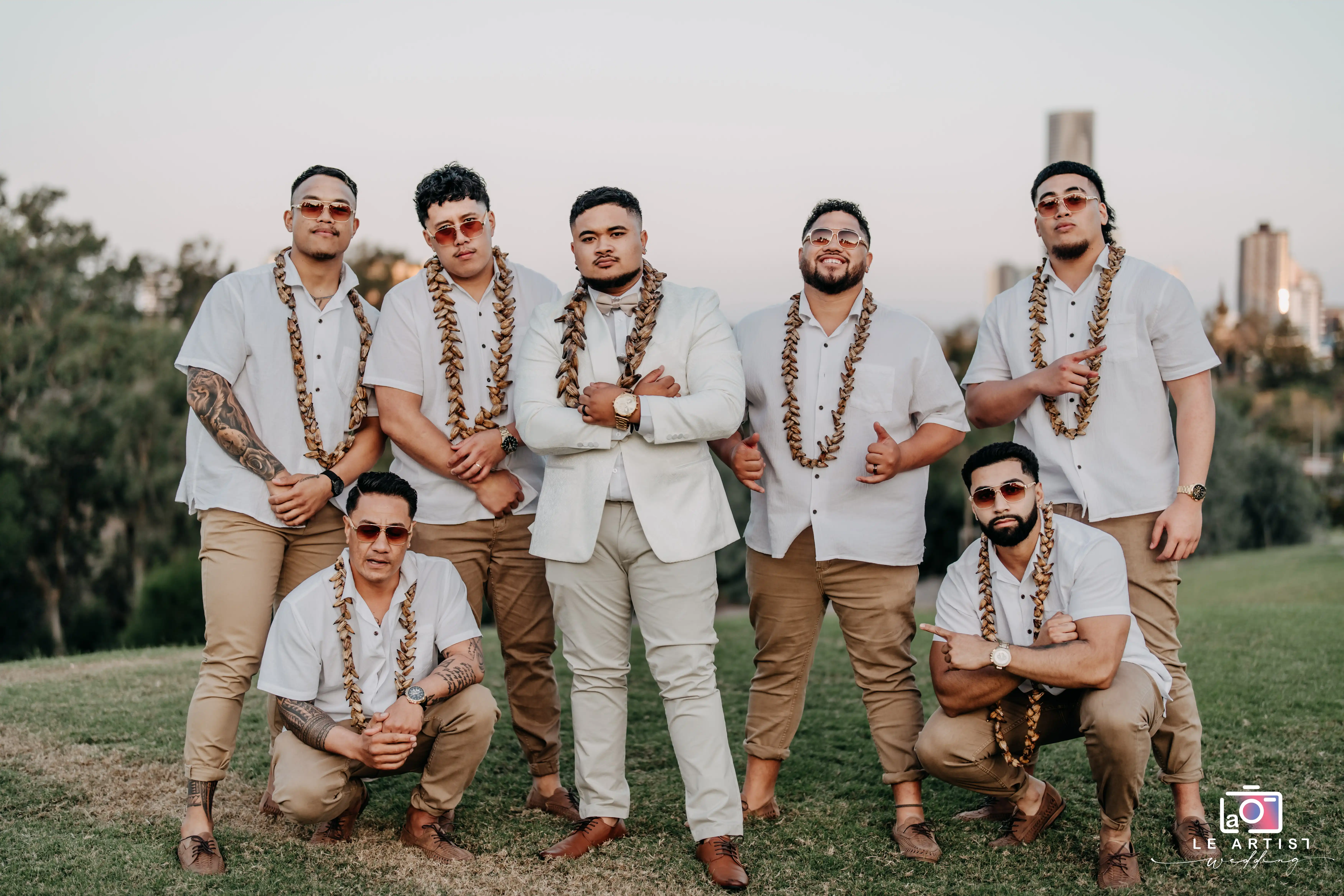Groomsmen strike a pose in matching attire and sunglasses, exuding style and camaraderie during the bridal party photoshoot. Le Artist Wedding