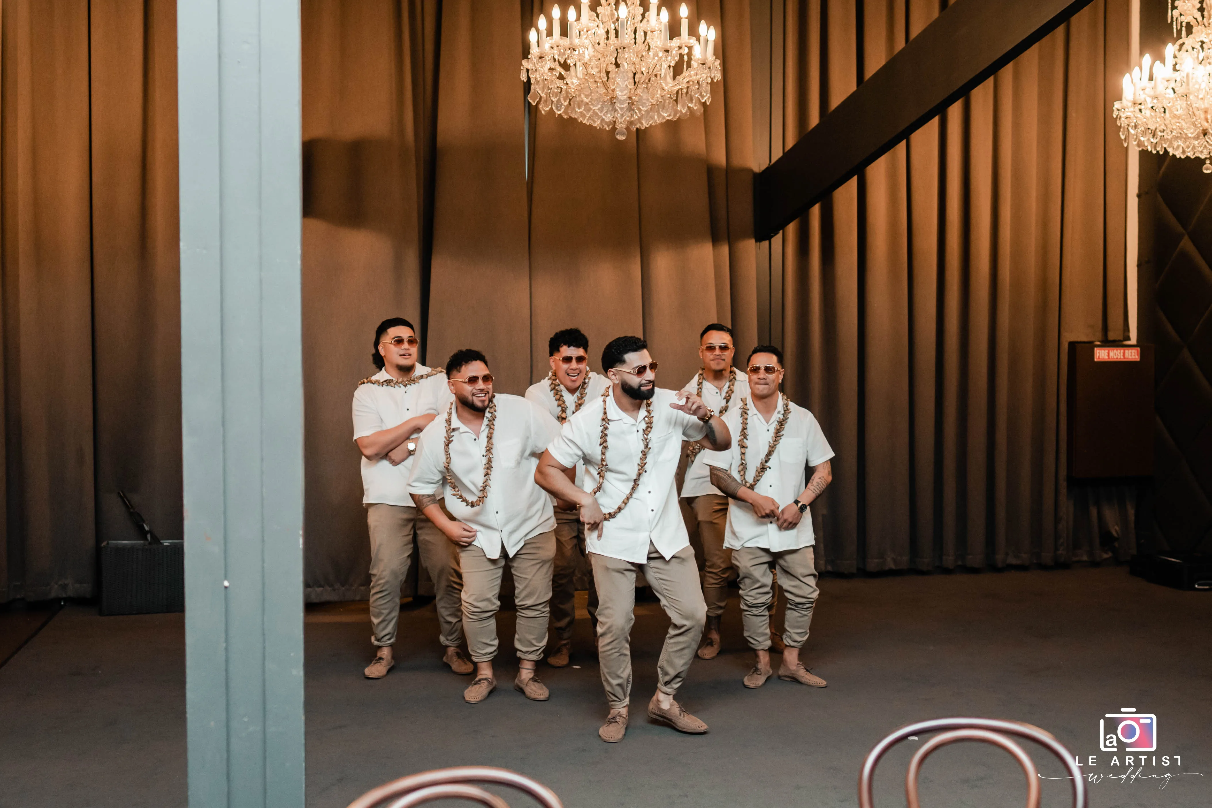 Groomsmen performing a lively dance during the reception party, creating an entertaining moment for the guests. Le Artist Wedding