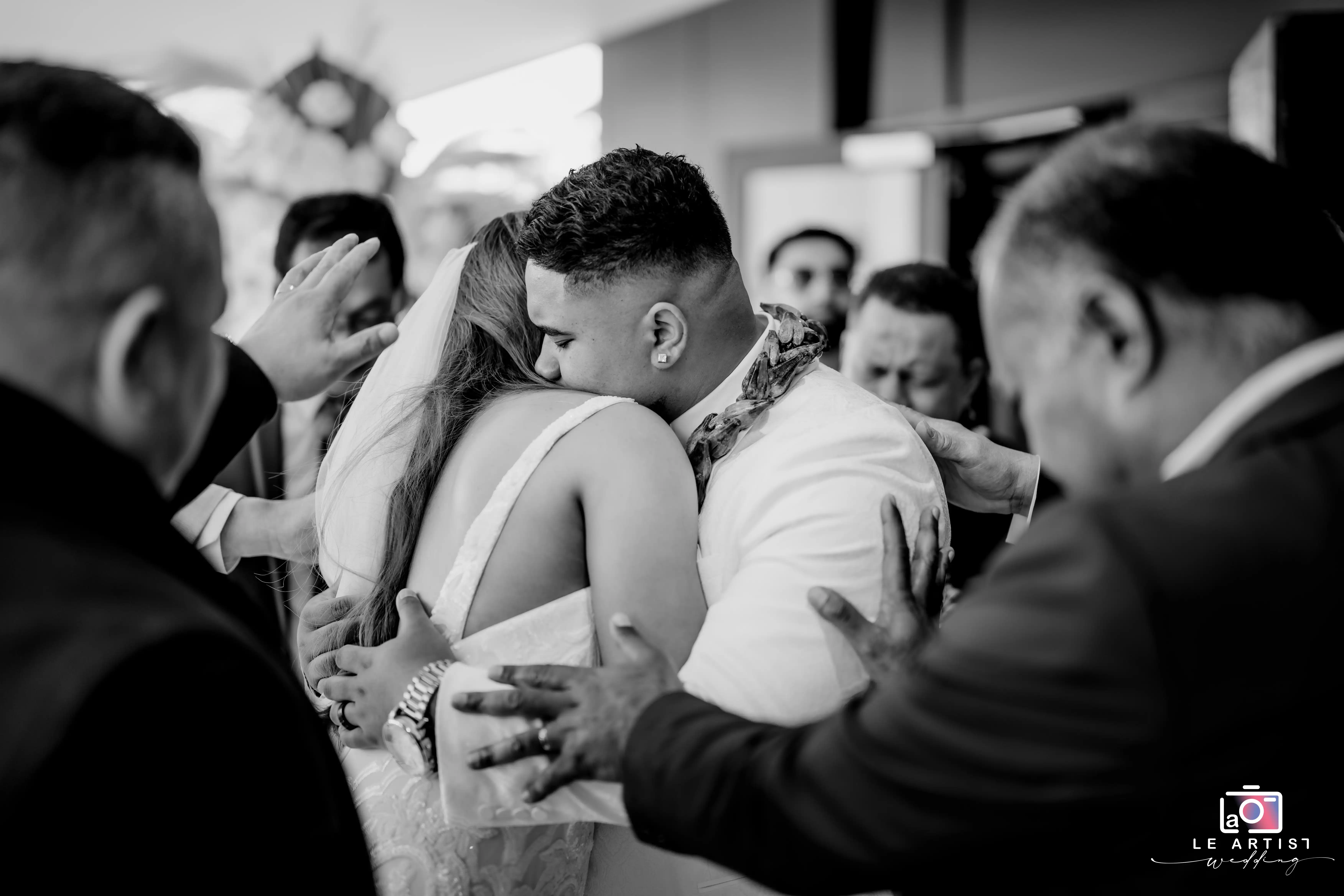 A tender embrace during the processional as loved ones offer their blessings. Le Artist Wedding