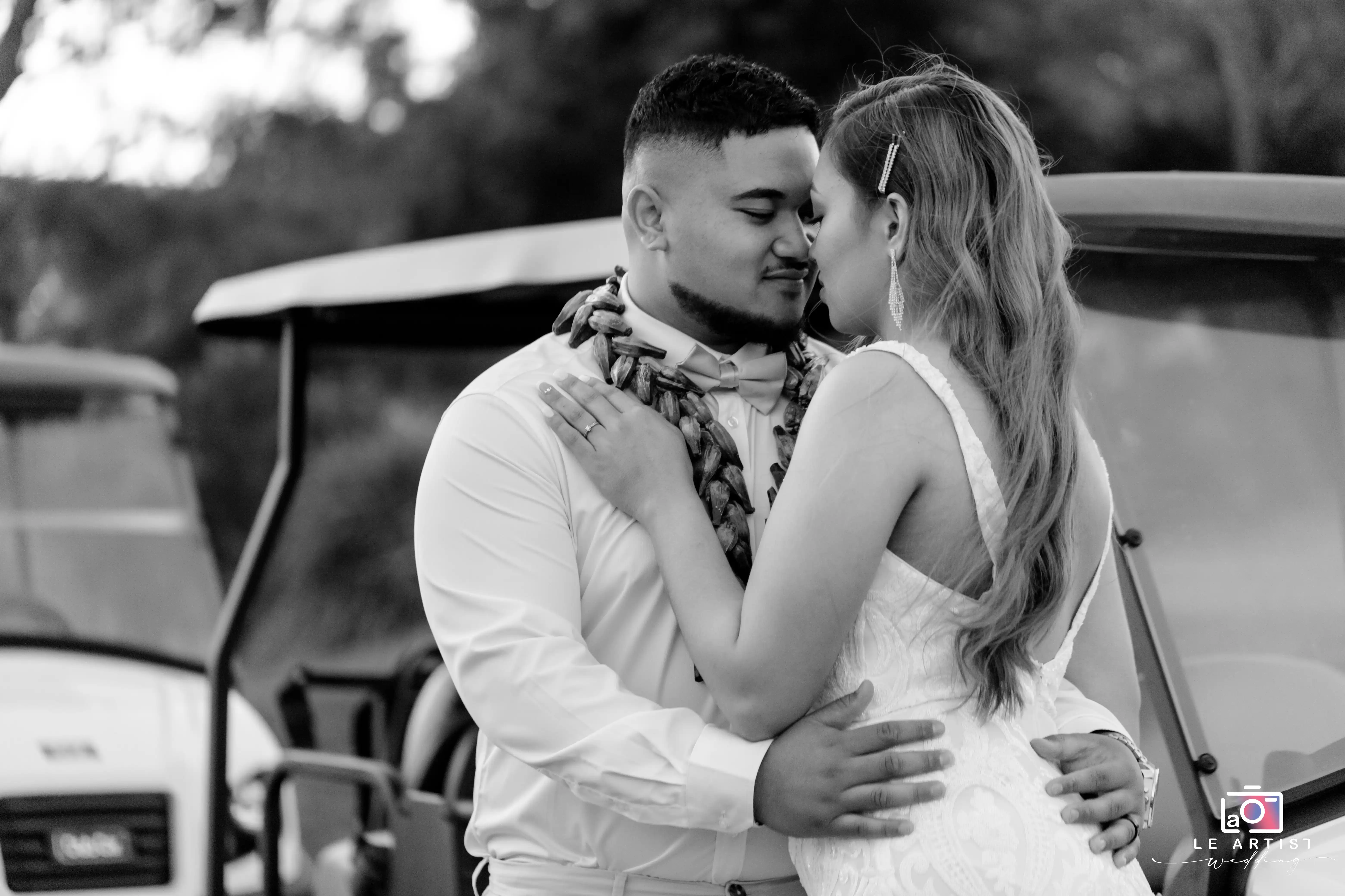 A tender moment between the newlyweds during a photoshoot, capturing their intimacy and love. Le Artist Wedding